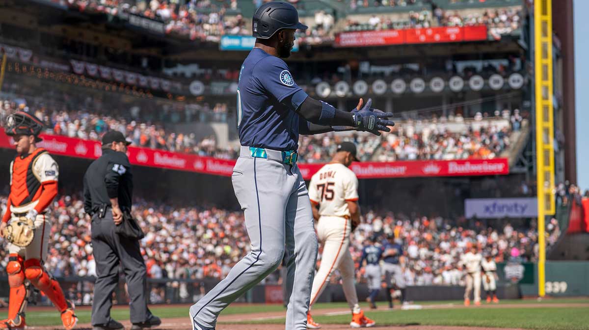 Seattle Mariners right fielder Victor Robles (10) claps and celebrates with Seattle Mariners left fielder Randy Arozarena (not pictured) for driving in the run during the ninth inning against the San Francisco Giants at Oracle Park.