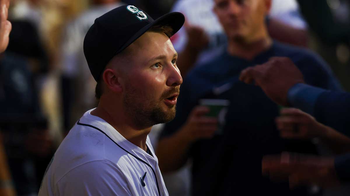Seattle Mariners catcher Cal Raleigh (29) talks with teammates in the dugout during a fifth inning pitching change by the San Diego Padres at T-Mobile Park.
