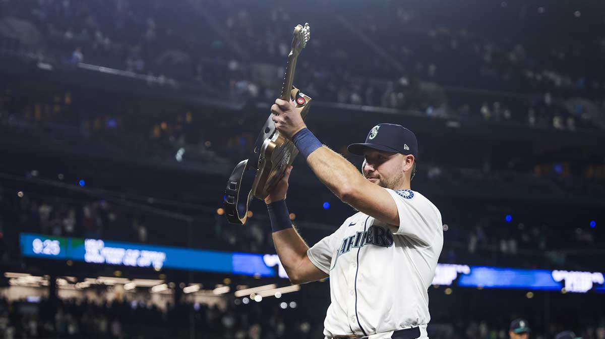 Seattle Mariners catcher Cal Raleigh (29) holds the “Vedder Cup” trophy for the winning the season series against the San Diego Padres following a victory Padres at T-Mobile Park. The “Vedder Cup” is named after Pearl Jam frontman Eddie Vedder.