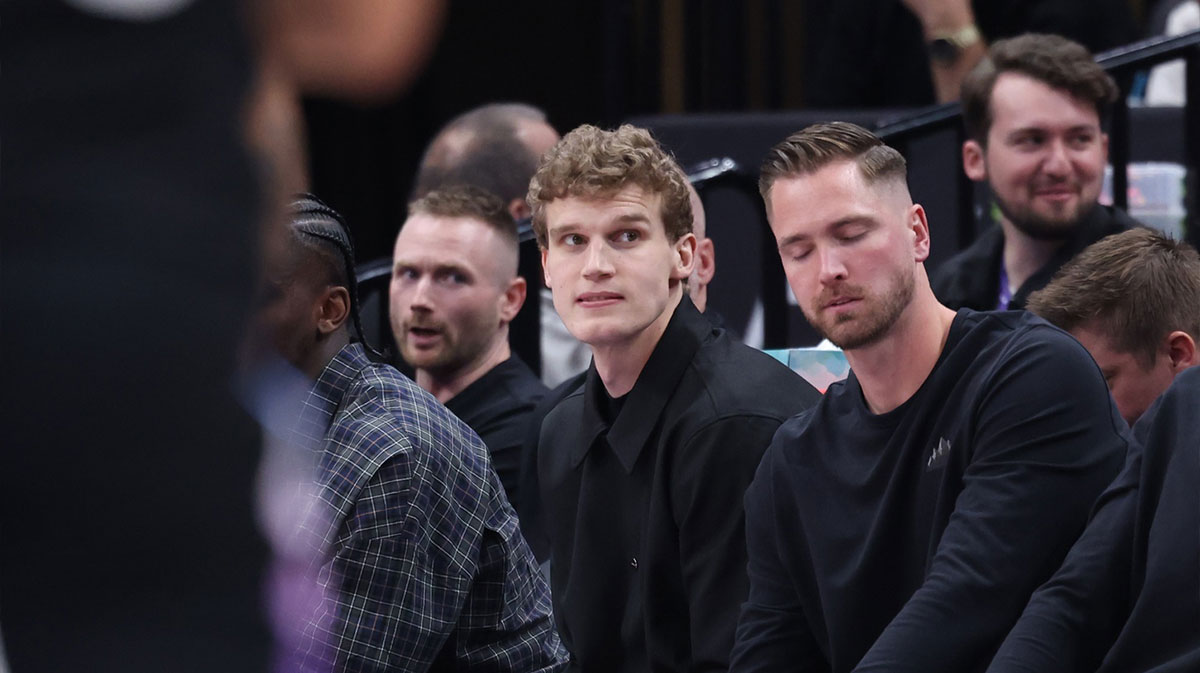 Utah Jazz forward Lauri Markkanen (center) watches the game from the bench during the second half of the game against the Houston Rockets at Delta Center.