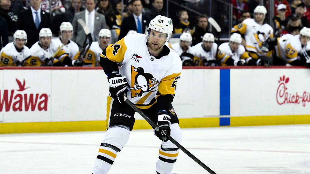 Pittsburgh Penguins defenseman Matt Grzelcyk (24) controls the puck during the third period against the New Jersey Devils at Prudential Center.