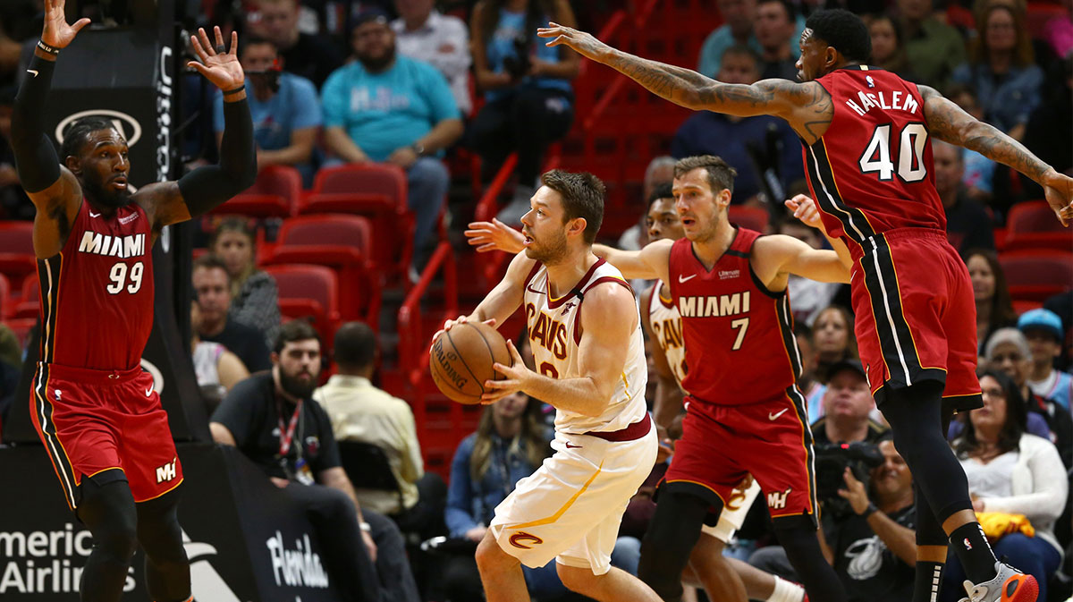 Cleveland Cavaliers guard Matthew Dellavedova (18) passes the ball against Miami Heat forward Jae Crowder (99) and forward Udonis Haslem (40) during the second half at American Airlines Arena.