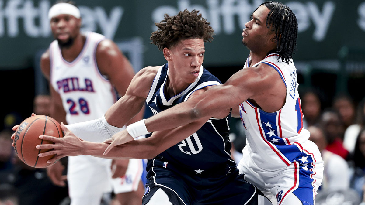 Mar 16, 2025; Dallas, Texas, USA; Dallas Mavericks forward Kessler Edwards (20) controls the ball as Philadelphia 76ers guard Ricky Council IV (14) defends during the second half at American Airlines Center.