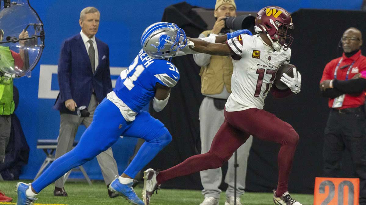 Washington Commanders wide receiver Terry McLaurin (17) runs the ball against Detroit Lions safety Kerby Joseph (31) during the second quarter at Ford Field.