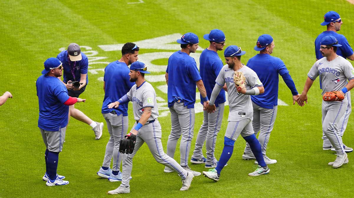 Aug 6, 2025; Denver, Colorado, USA; Members of the Toronto Blue Jays celebrate defeating the Colorado Rockies at Coors Field. Mandatory Credit: Ron Chenoy-Imagn Images