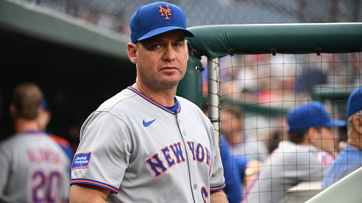 New York Mets manager Carlos Mendoza (64) stands in the dugout before a game against the Washington Nationals at Nationals Park.