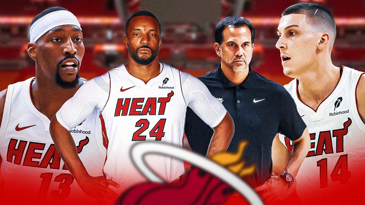 Miami Heat stars Norman Powell with a Heat jersey (number 24) and Erik Spoelstra in the center with Bam Adebayo and Tyler Herro on either side in front of Kaseya Center.