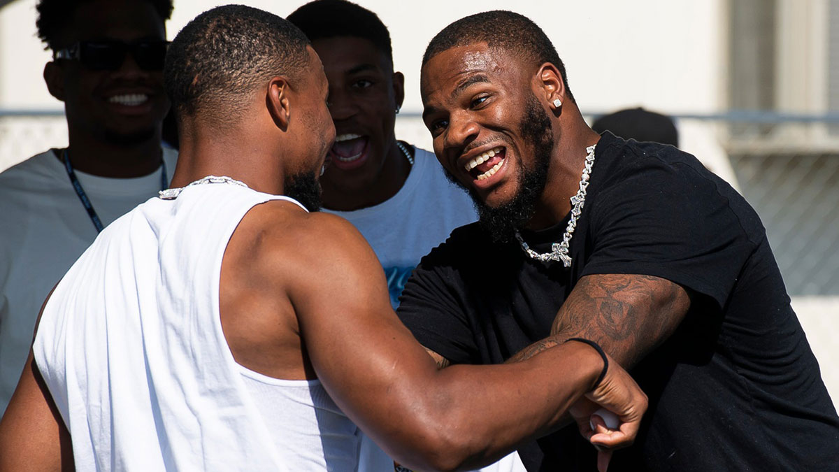 Penn State lettermen Micah Parsons (right) and Saquon Barkley joke around while playing pong at a NIL tailgate outside Beaver Stadium September 2, 2023, in State College.