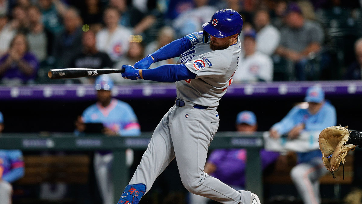 Aug 29, 2025; Denver, Colorado, USA; Chicago Cubs first baseman Michael Busch (29) hits a single in the fifth inning against the Colorado Rockies at Coors Field.