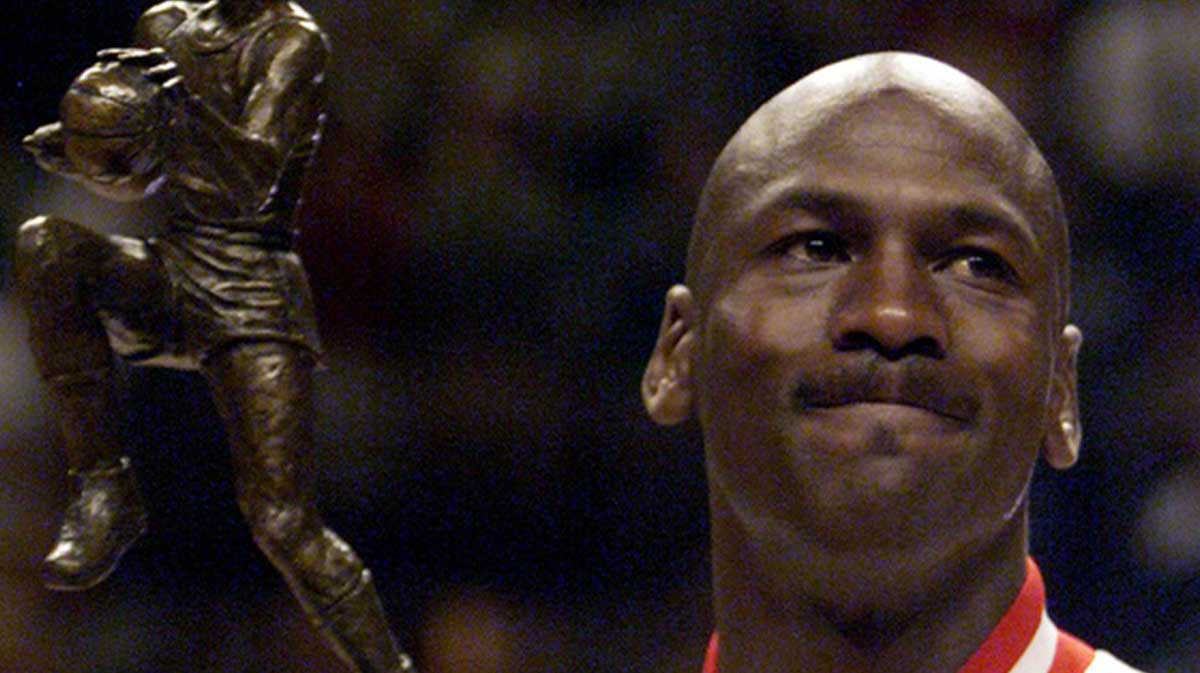 Chicago Bulls guard Michael Jordan holds up his fifth MVP trophy before the playoff game against the Indiana Pacers at the United Center.