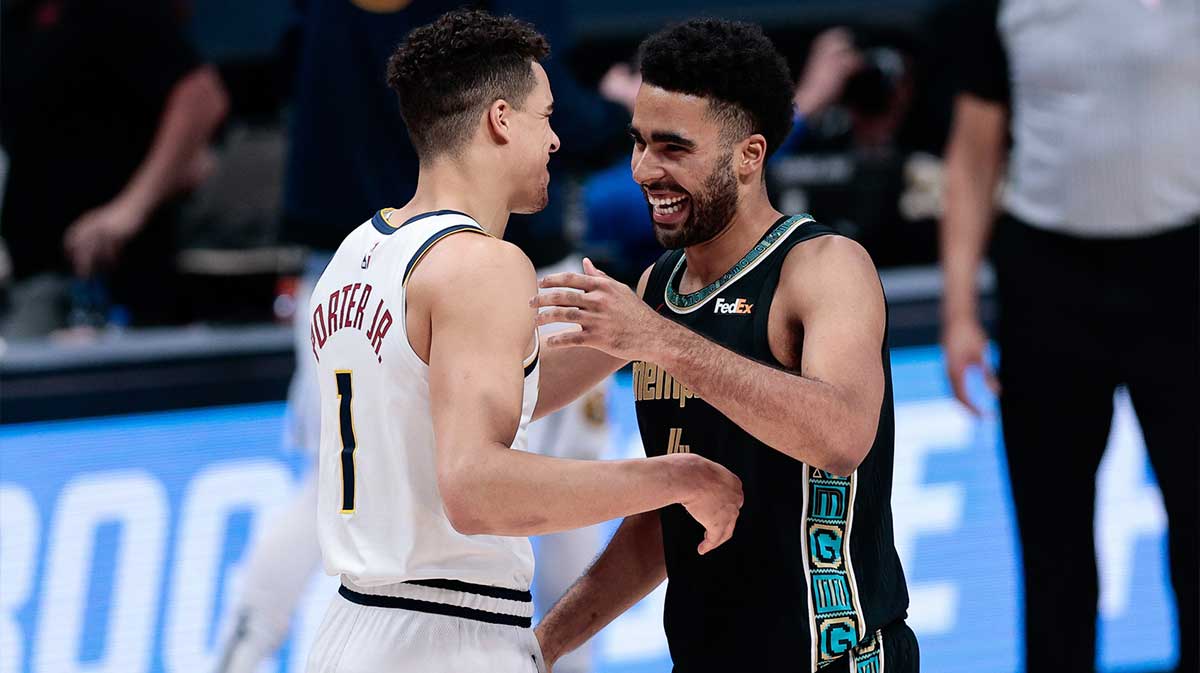 Denver Nuggets forward Michael Porter Jr. (1) greets his brother Memphis Grizzlies forward Jontay Porter (R) after the game at Ball Arena.