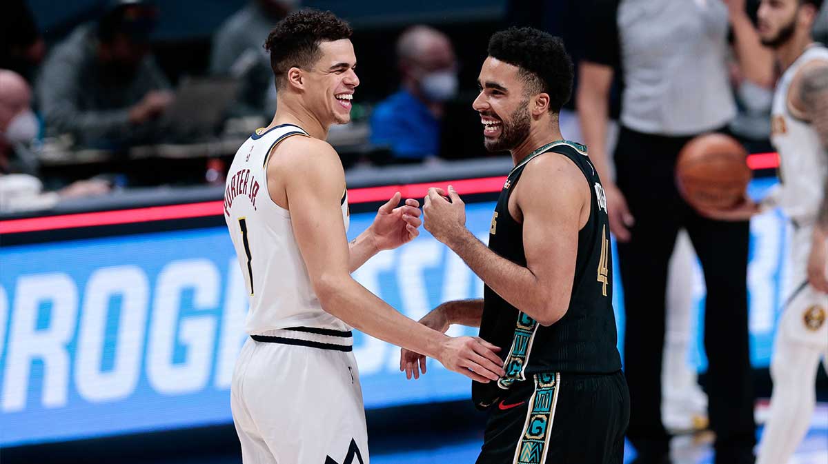Denver Nuggets forward Michael Porter Jr. (1) greets his brother Memphis Grizzlies forward Jontay Porter (4) after the game at Ball Arena.
