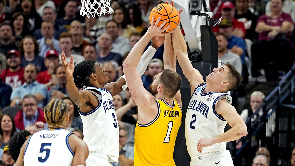 Michigan Wolverines center Hunter Dickinson (1) shoots the ball against Villanova Wildcats guard Collin Gillespie (2) in the semifinals of the South regional of the men's college basketball NCAA Tournament at AT&T Center.