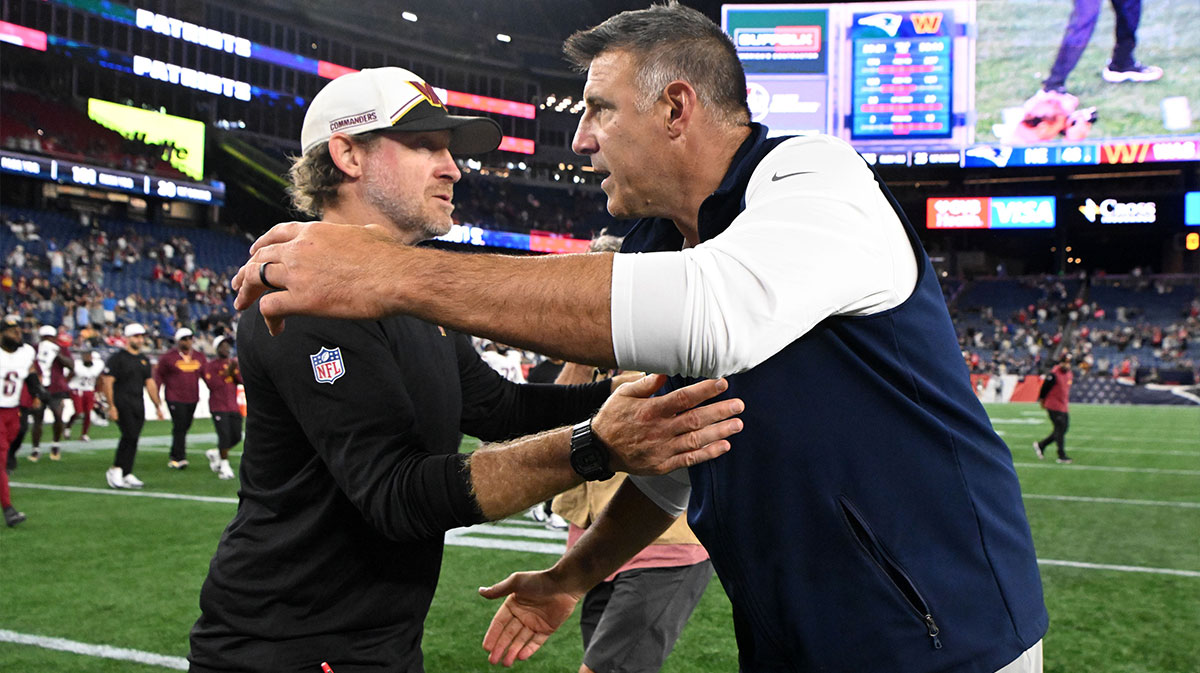 New England Patriots head coach Mike Vrabel hugs Washington Commanders special teams coach Larry Izzo after a game at Gillette Stadium.