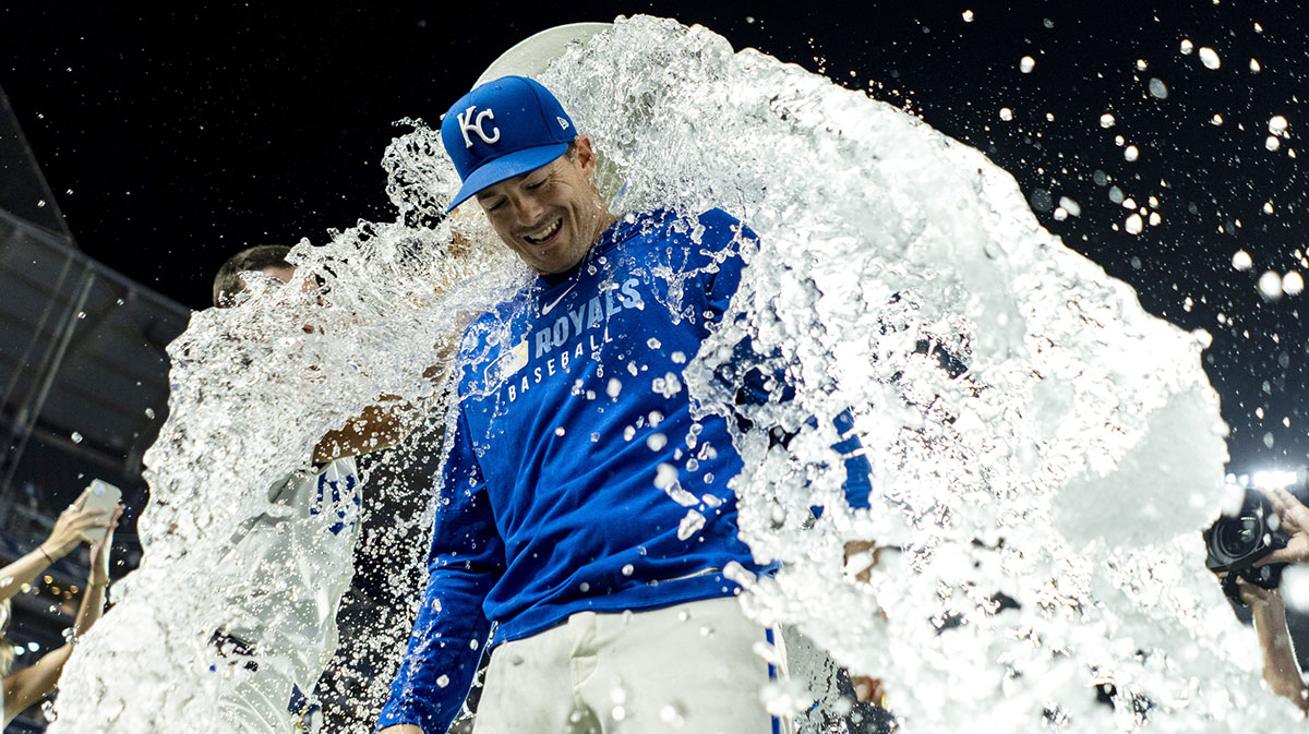 Kansas City Royals designated hitter Mike Yastrzemski (18) is doused with water by center fielder Kyle Isbel (28) and shortstop Bobby Witt Jr. (7) after defeating the Texas Rangers at Kauffman Stadium.