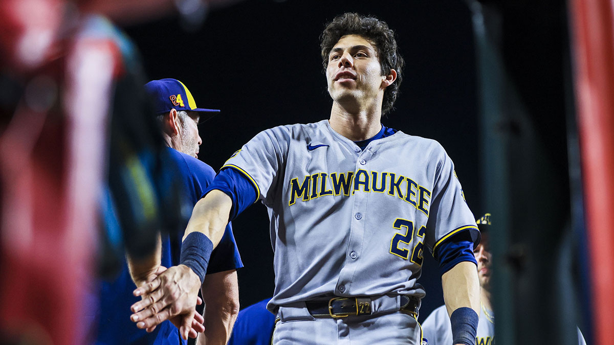 Milwaukee Brewers designated hitter Christian Yelich (22) high fives teammates after the victory over the Cincinnati Reds at Great American Ball Park.