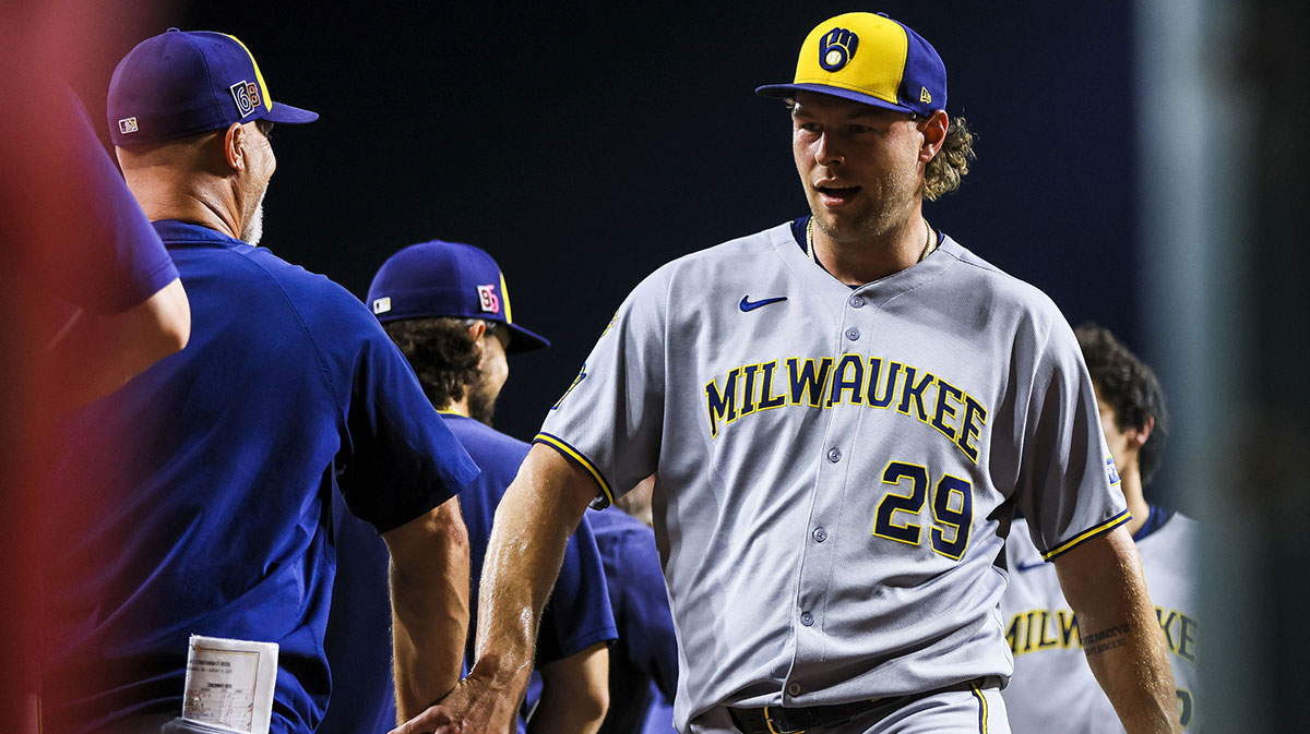 Milwaukee Brewers relief pitcher Trevor Megill (29) high fives teammates after the victory over the Cincinnati Reds at Great American Ball Park.