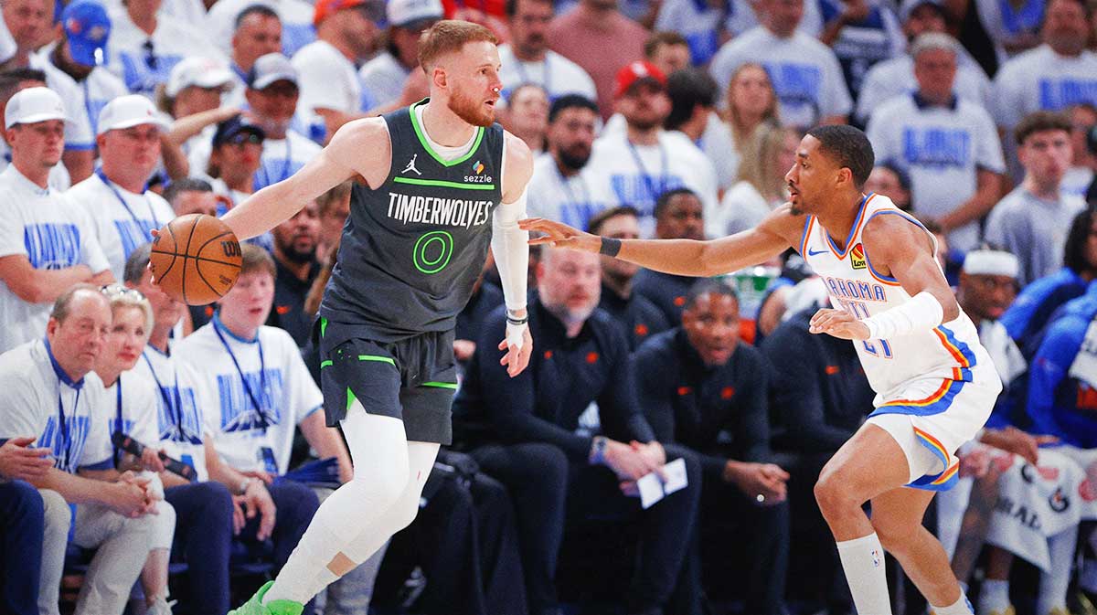 Minnesota Timberwolves guard Donte DiVincenzo (0) moves the ball against Oklahoma City Thunder guard Aaron Wiggins (21) in the fourth quarter during game one of the western conference finals for the 2025 NBA Playoffs at Paycom Center. Mandatory Credit: Alonzo Adams-Imagn Images