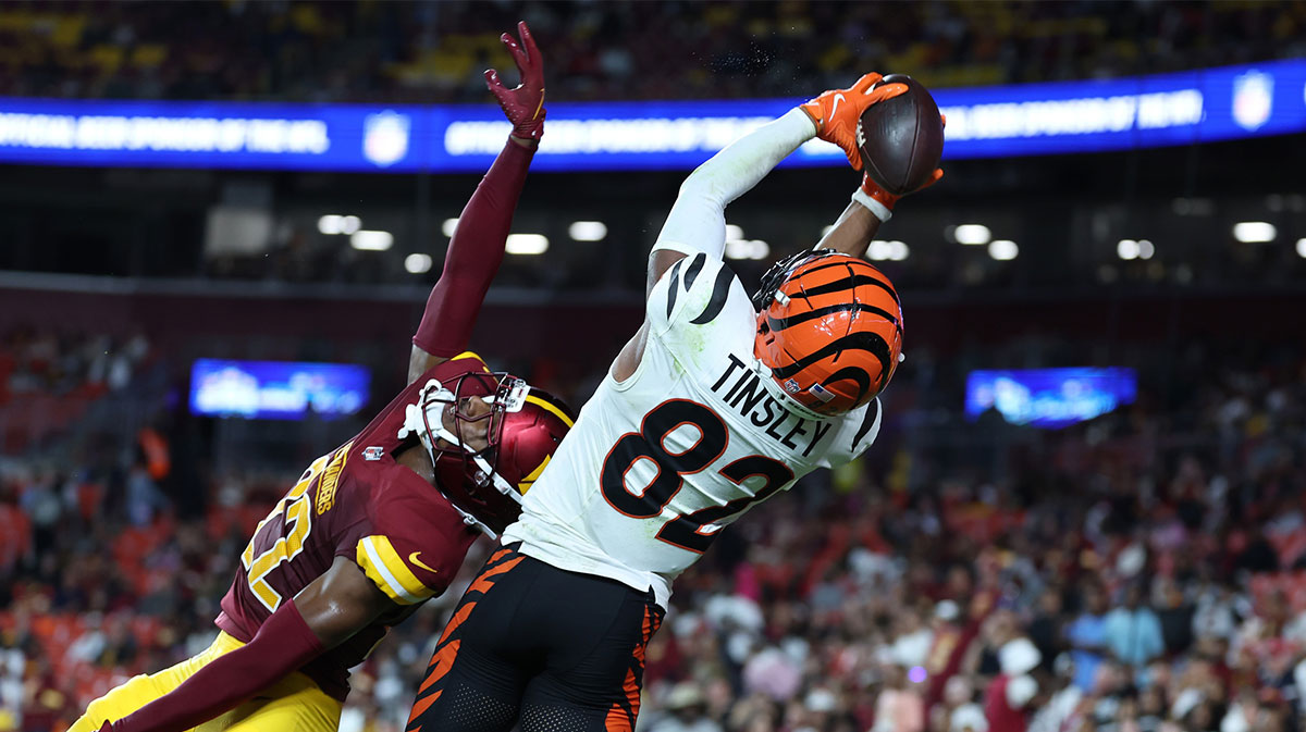 Aug 18, 2025; Landover, Maryland, USA; Cincinnati Bengals wide receiver Mitchell Tinsley (82) catches a touchdown pass over Washington Commanders cornerback Car'lin Vigers (22) during the first half at Northwest Stadium. 