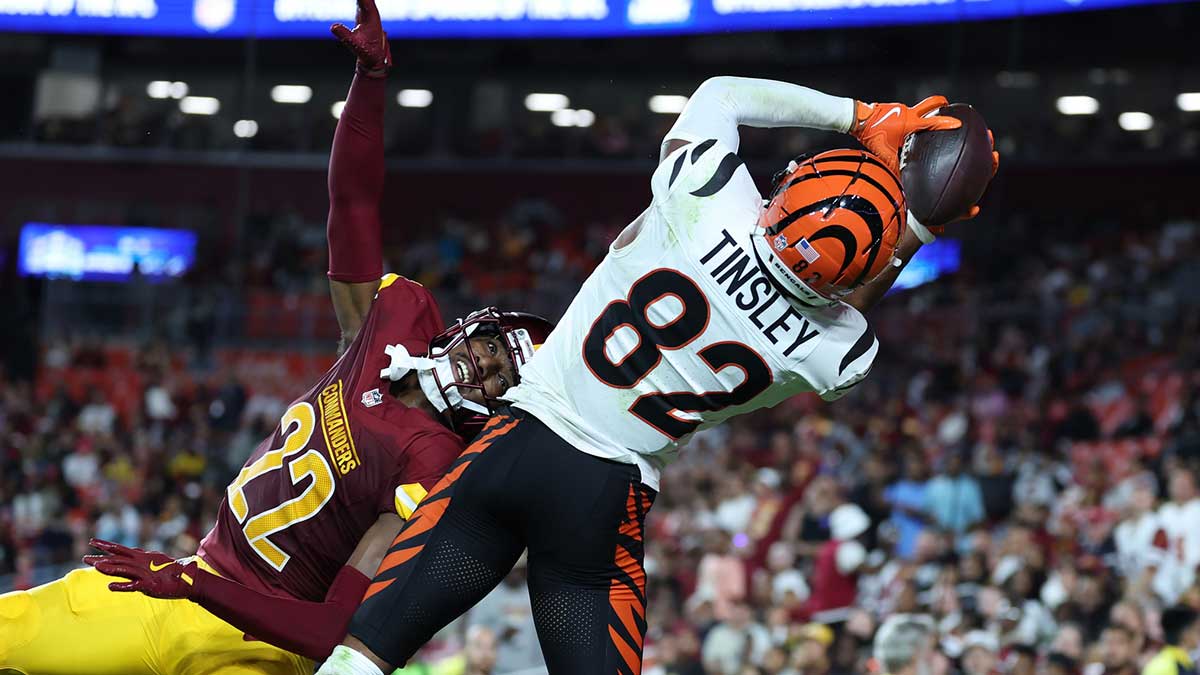 Cincinnati Bengals wide receiver Mitchell Tinsley (82) catches a touchdown pass over Washington Commanders cornerback Car'lin Vigers (22) during the first half at Northwest Stadium.