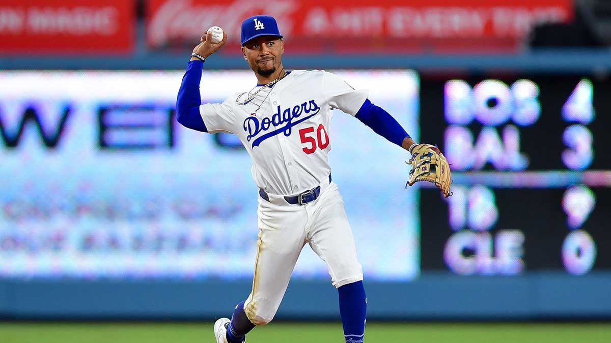 Los Angeles Dodgers shortstop Mookie Betts (50) throws to first for the out against Cincinnati Reds shortstop Elly De La Cruz (44) during the ninth inning at Dodger Stadium.