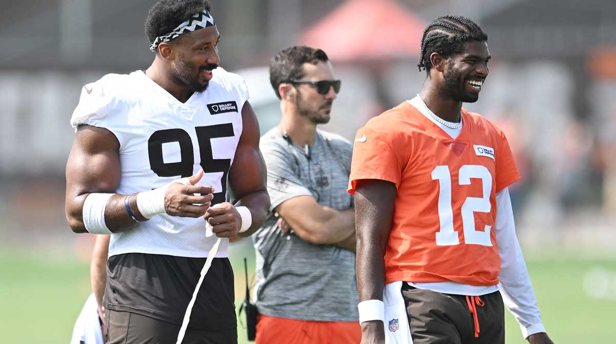 Cleveland Browns defensive end Myles Garrett (95) talks to quarterback Shedeur Sanders (12) during training camp at CrossCountry Mortgage Campus.