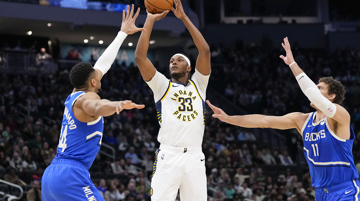 Indiana Pacers center Myles Turner (33) shoot between Milwaukee Bucks forward Giannis Antetokounmpo (34) and center Brook Lopez (11) during the first quarter at Fiserv Forum