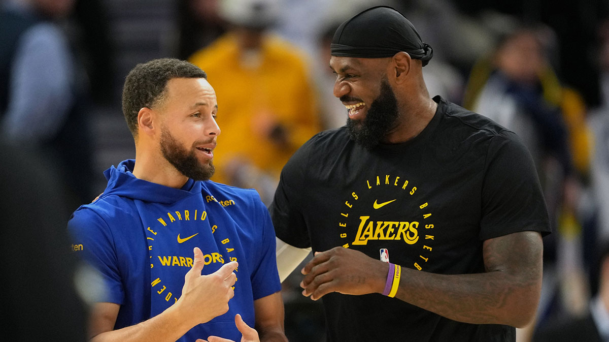 Golden State Warriors guard Stephen Curry (left) and Los Angeles Lakers forward LeBron James (right) talk before the game at Chase Center.