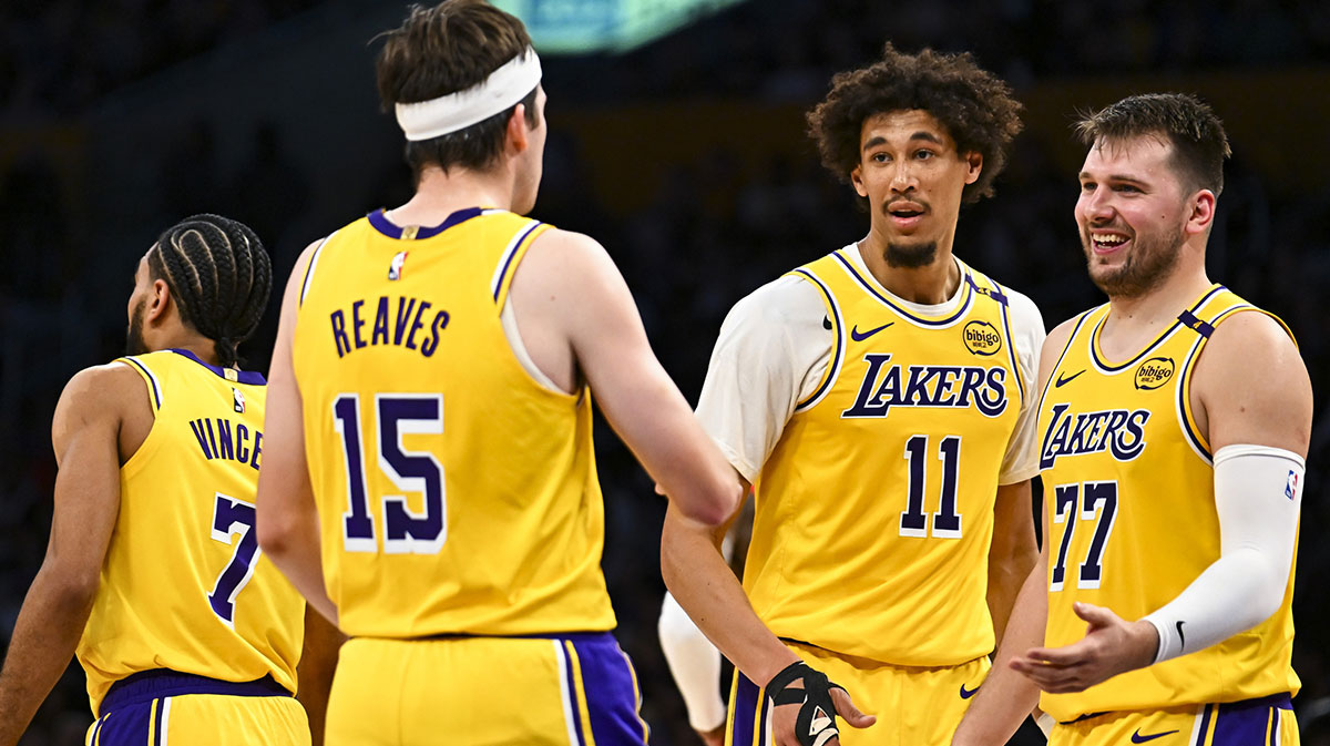 Los Angeles Lakers guard Luka Doncic (77) celebrates with center Jaxson Hayes (11), and guard Austin Reaves (15) after scoring against the Houston Rockets during the first half at Crypto.com Arena.