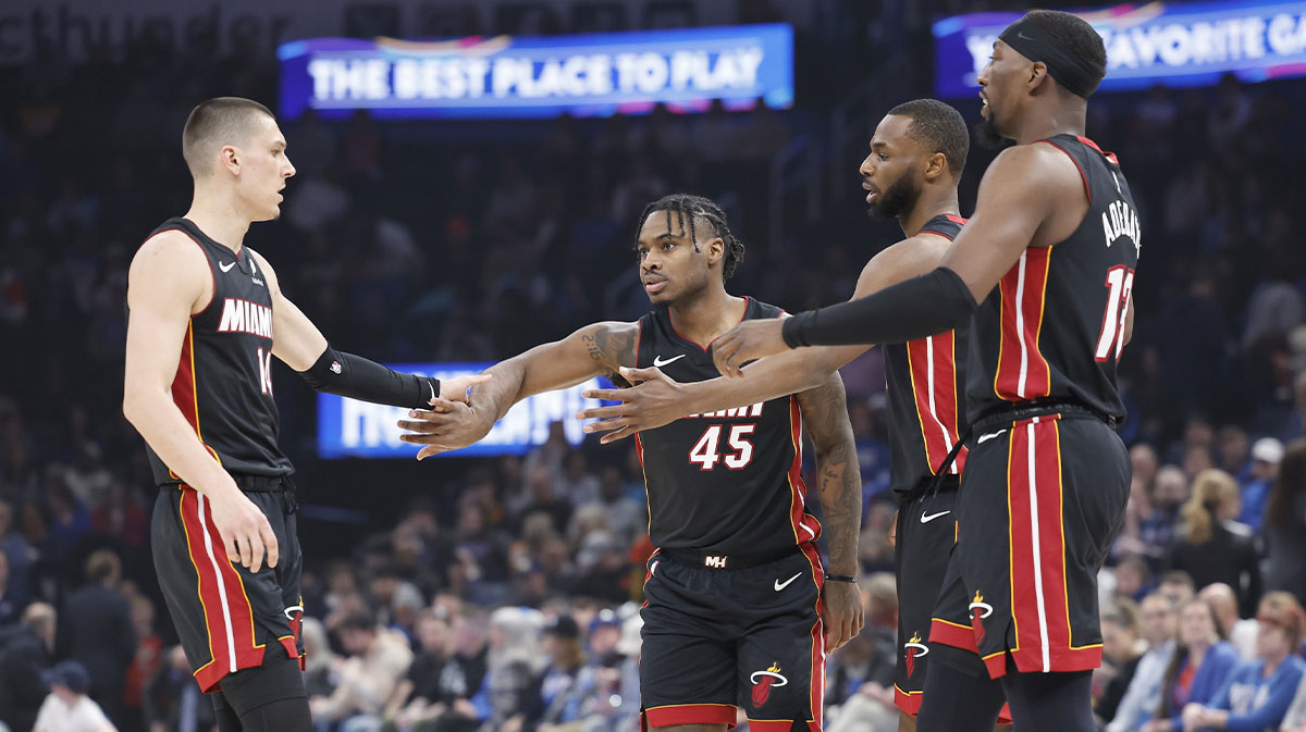 Miami Heat guard Tyler Herro (14), guard Davion Mitchell (45), forward Andrew Wiggins (22) and center Bam Adebayo (13) high five after a play against the Oklahoma City Thunder during the first quarter at Paycom Center.