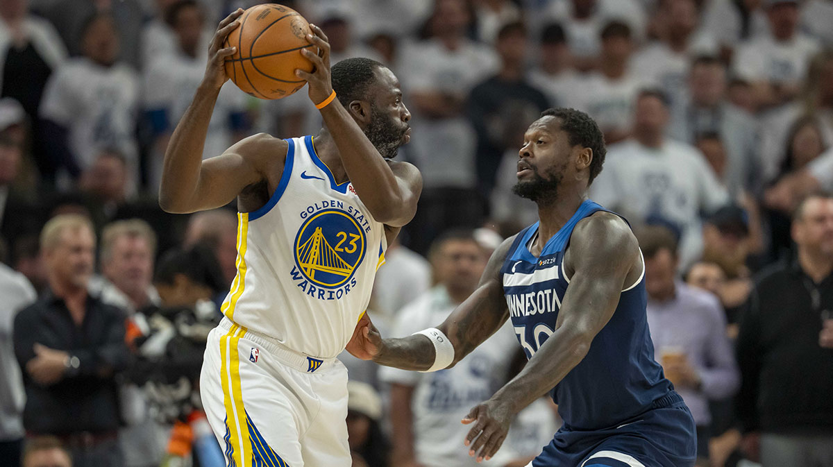 May 14, 2025; Minneapolis, Minnesota, USA; Golden State Warriors forward Draymond Green (23) holds the ball up as Minnesota Timberwolves forward Julius Randle (30) plays defense in the first half during game five of the second round for the 2025 NBA Playoffs at Target Center.