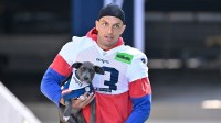 New England Patriots wide receiver Mack Hollins (13) delivers a puppy to a local family before addressing the media during training camp at Gillette Stadium.