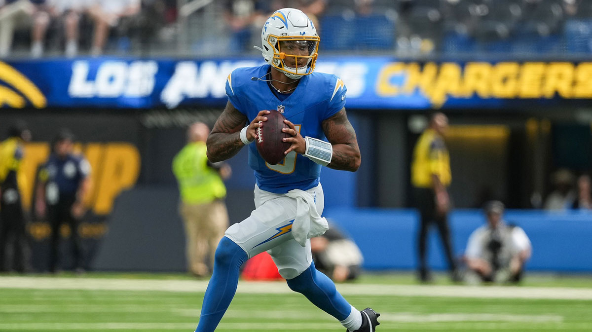 Los Angeles Chargers quarterback Trey Lance (5) runs against the New Orleans Saints during the third quarter at SoFi Stadium.