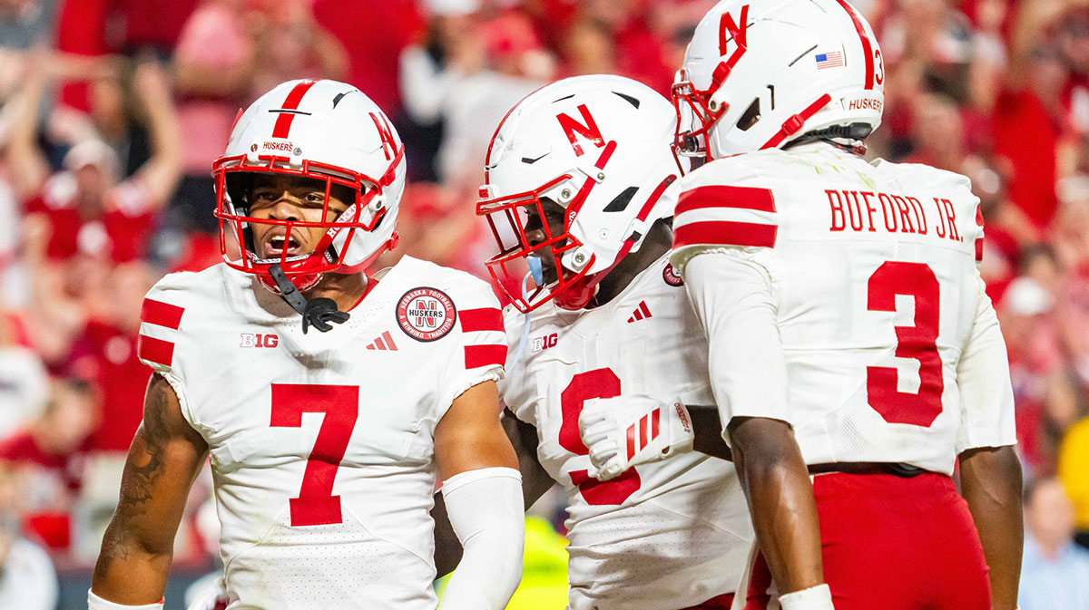 Nebraska Cornhuskers defensive back Malcolm Hartzog Jr. (7) celebrates with linebacker Vincent Shavers Jr. (9) and defensive back Marques Buford Jr. (3) after an interception against the Cincinnati Bearcats during the fourth quarter at GEHA Field at Arrowhead Stadium.
