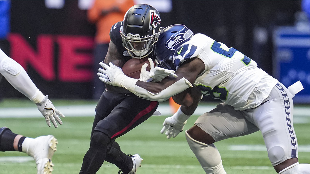 Atlanta Falcons running back Jase McClellan (30) is hit by Seattle Seahawks linebacker Derick Hall (58) during the second half at Mercedes-Benz Stadium.