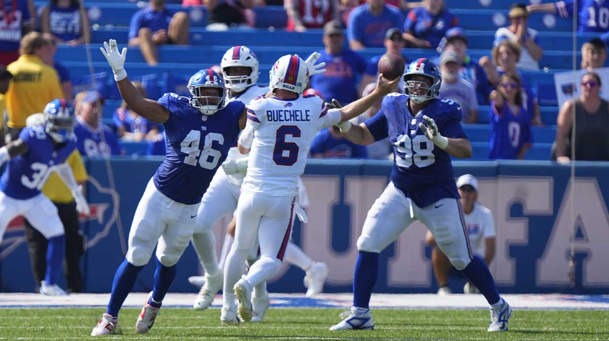 New York Giants linebacker Trace Ford (46) and New York Giants defensive tackle D.J. Davidson (98) defend against Buffalo Bills quarterback Shane Buechele (6) throwing the ball during the second half at Highmark Stadium.