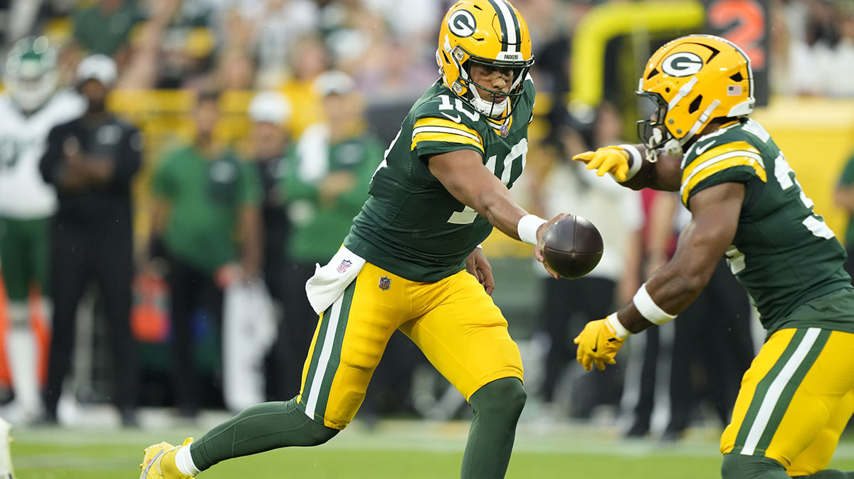 Green Bay Packers quarterback Jordan Love (10) hands off the ball to Green Bay Packers running back Chris Brooks (30) during the first quarter against the New York Jets at Lambeau Field.