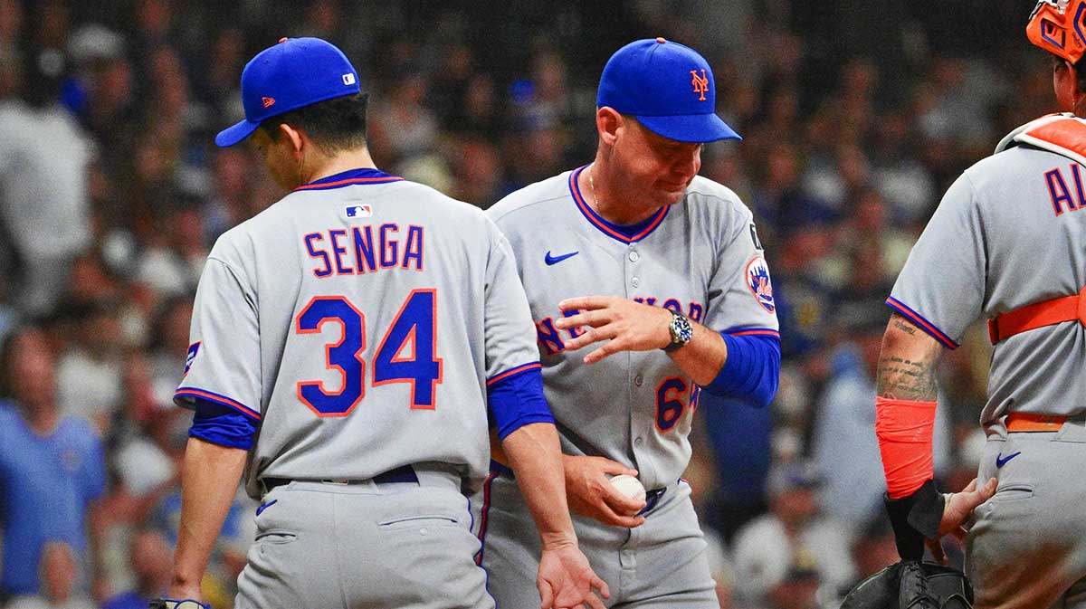 New York Mets manager Carlos Mendoza takes the ball from starting pitcher Kodai Senga (34) during a pitching change in the fifth inning against the Milwaukee Brewers at American Family Field. Mandatory Credit: Benny Sieu-Imagn Images