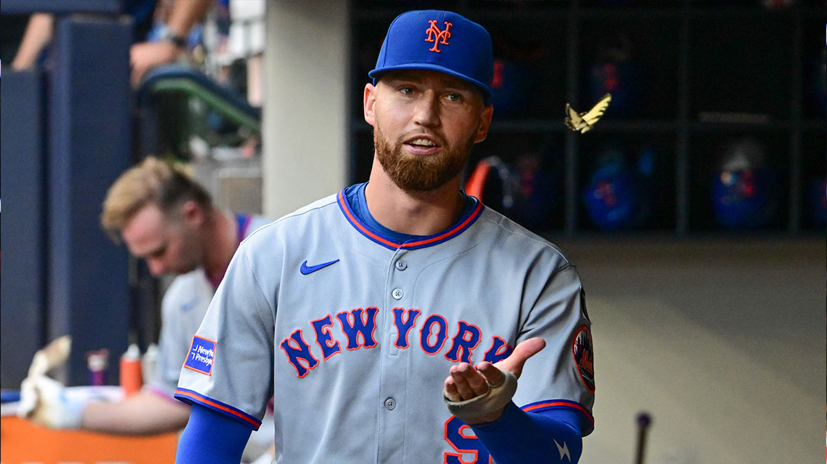 New York Mets left fielder Brandon Nimmo (9) chases a butterfly in the dugout during game against the Milwaukee Brewers at American Family Field.