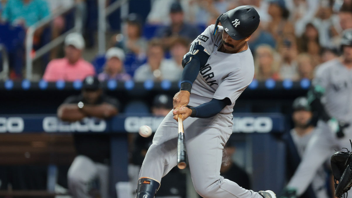 New York Yankees center fielder Trent Grisham (12) hits a home run against the Miami Marlins during the first inning at loanDepot Park.