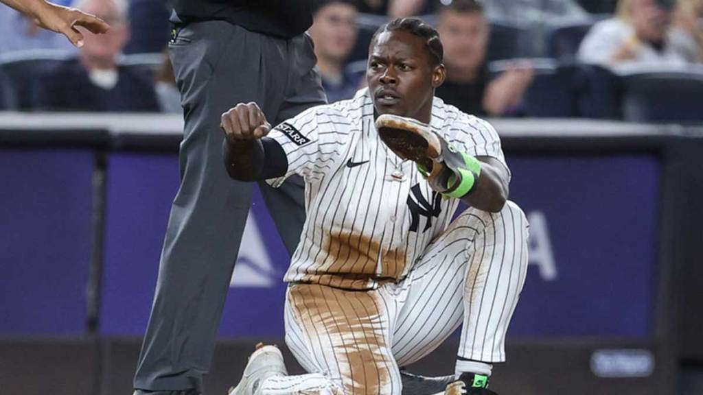 New York Yankees second baseman Jazz Chisholm Jr. (13) gestures after slidig slides safely into third base following a throwing error in the fourth inning against the Boston Red Sox at Yankee Stadium.