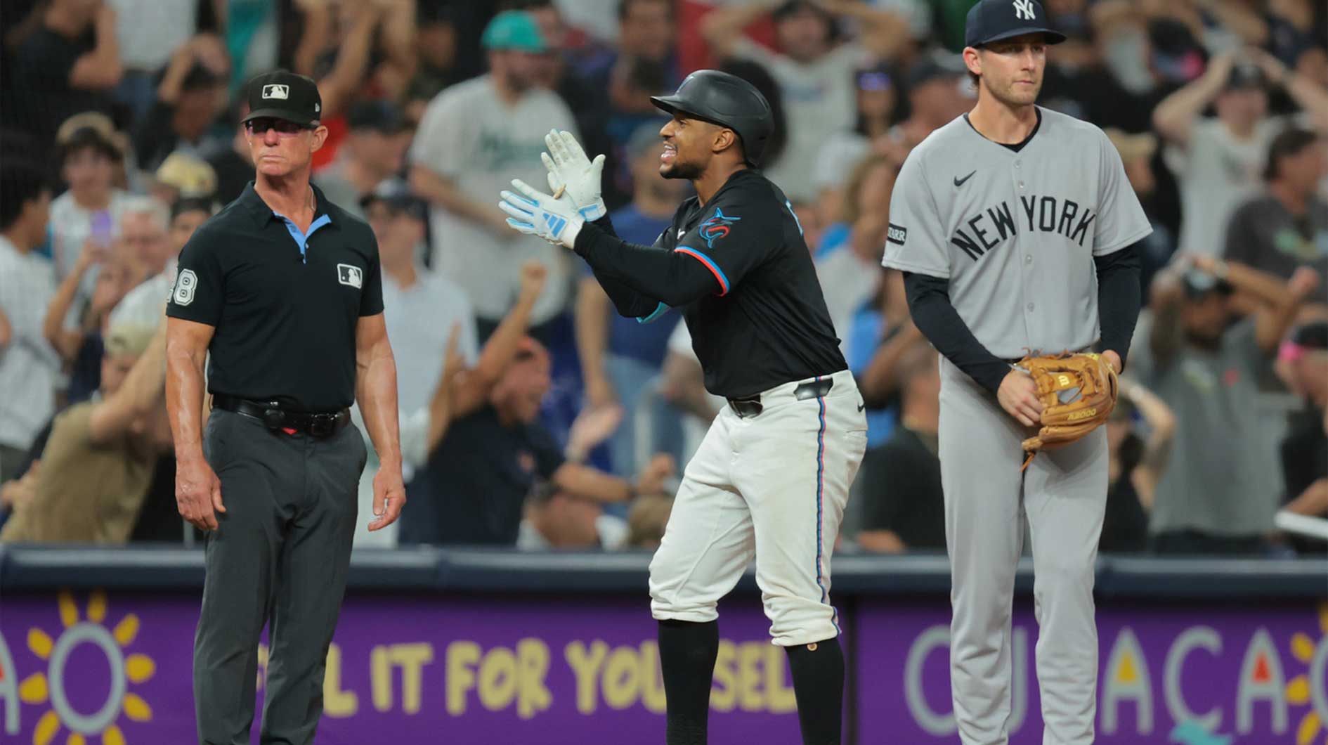 Miami Marlins second baseman Xavier Edwards (9) reacts after reaching third base against the New York Yankees during the ninth inning at loanDepot Park.