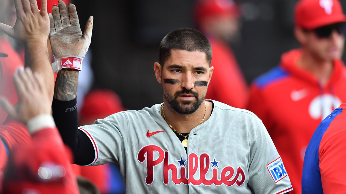 Philadelphia Phillies right fielder Nick Castellanos (8) celebrates with teammates in the dugout after scoring during the fourth inning against the Chicago White Sox at Rate Field.