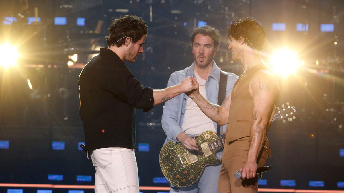 Nick, Kevin, and Joe Jonas performing on tour in 2023.