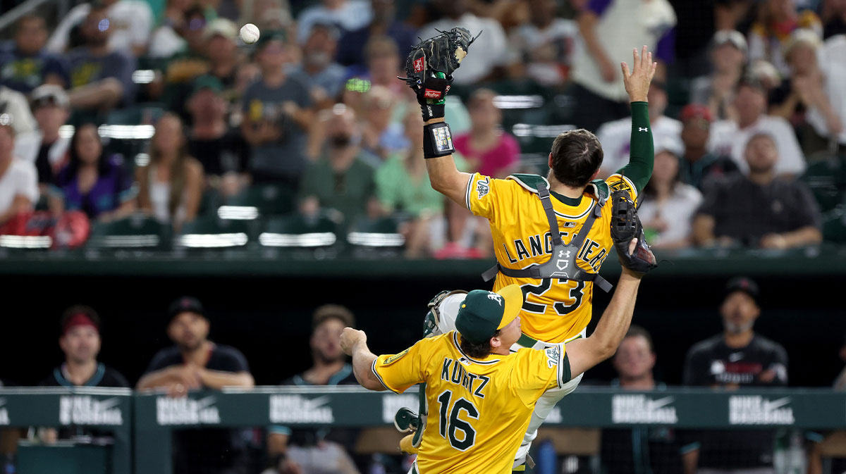 Athletics first baseman Nick Kurtz (16) and A's catcher Shea Langeliers (23) collide while attempting to catch a foul ball against the Arizona Diamondbacks during the seventh inning at Sutter Health Park.