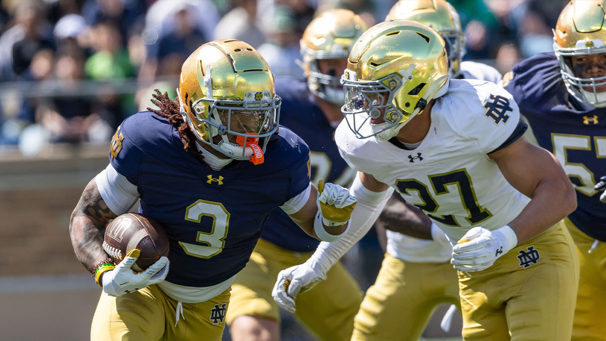 Notre Dame Fighting Irish running back Gi'Bran Payne (3) runs the ball as linebacker Kyngstonn Viliamu-Asa (27) goes to tackle him during the Blue-Gold game at Notre Dame Stadium.