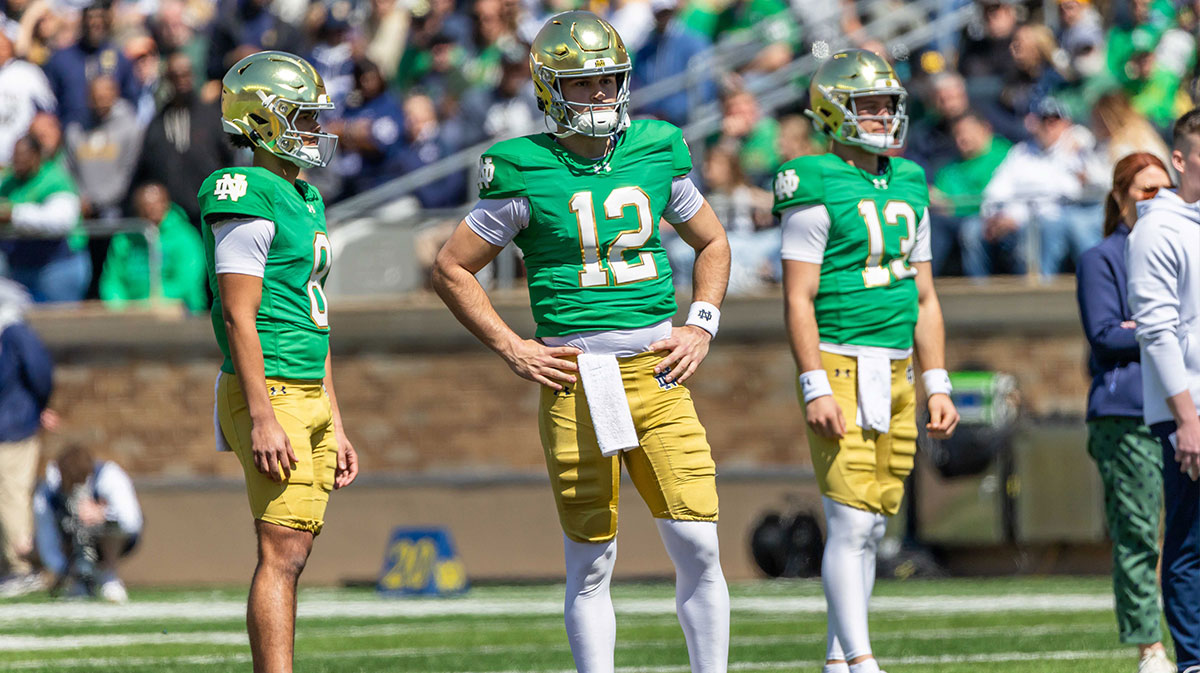 Notre Dame Fighting Irish quarterback Kenny Minchey (8), Notre Dame Fighting Irish quarterback Blake Hebert (12), Notre Dame Fighting Irish quarterback CJ Carr (13) watch during the Blue-Gold game at Notre Dame Stadium.