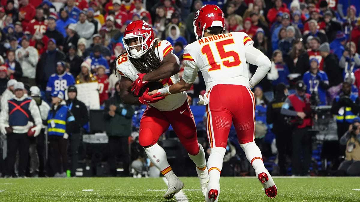 Nov 17, 2024; Orchard Park, New York, USA; Kansas City Chiefs quarterback Patrick Mahomes (15) hands the ball off to Kansas City Chiefs running back Kareem Hunt (29) against the Buffalo Bills during the second half at Highmark Stadium. Mandatory Credit: Gregory Fisher-Imagn Images
