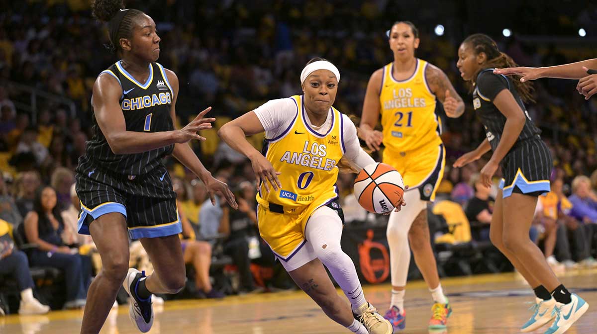 Los Angeles Sparks guard Odyssey Sims (0), now of the Fever, drives past Chicago Sky center Elizabeth Williams (1) in the first half at Crypto.com Arena.