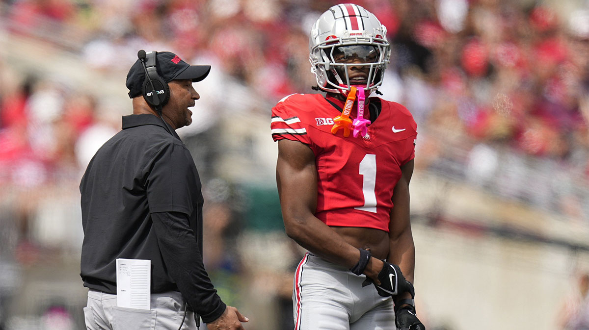 Aug 31, 2024; Columbus, OH, USA; Ohio State Buckeyes secondary coach Tim Walton talks to cornerback Davison Igbinosun (1) during the first half of the NCAA football game against the Akron Zips at Ohio Stadium.